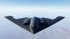 B-2 Spirit Stealth Bomber Flying Over Snowy Terrain, Aerial Photograph. Modern Military Aviation and Technology Concept. Blue Sky background