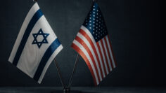 Table flag of United States America and Israel on dark background. Cooperation between two countries.