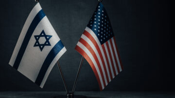 Table flag of United States America and Israel on dark background. Cooperation between two countries.