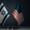 Table flag of United States America and Israel on dark background. Cooperation between two countries.