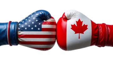 Boxing gloves with US and Canadian flags symbolize the trade war between the two countries.