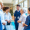 Medical team talking and smiling in hospital corridor