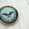 KYIV, UKRAINE – SEPTEMBER 17, 2025 US Department of War badge on white wooden table surface