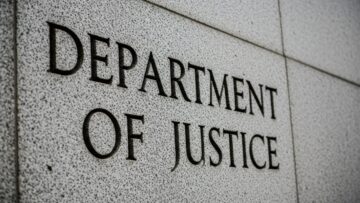 Department of Justice” engraved in grey, stone-like wall, close up