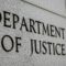 Department of Justice” engraved in grey, stone-like wall, close up