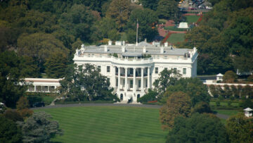 Aerial view of the White House from the top of the Washington Monument in Washington DC, surrounded by trees and city buildings