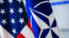 Close-up of the United States flag alongside the NATO flag, symbolizing alliance and cooperation.