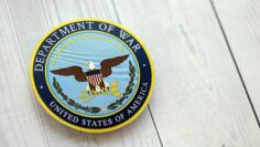 KYIV, UKRAINE – SEPTEMBER 17, 2025 US Department of War badge on white wooden table surface