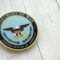 KYIV, UKRAINE – SEPTEMBER 17, 2025 US Department of War badge on white wooden table surface
