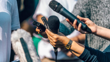 Journalists Interviewing. Female Speaker Answering Questions