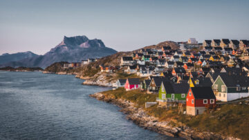 Nuuk capital of Greenland with Beautiful small colorful houses in myggedalen during Sunset Sunrise Midnight Sun. Sermitsiaq Mountain in Background. Blue and pink Sky.
