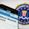 Stuttgart, Germany – 07-09-2023: Smartphone with website of US Federal Bureau of Investigation (FBI) on screen in front of seal. Focus on top-left of phone display.