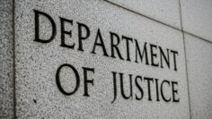 Department of Justice” engraved in grey, stone-like wall, close up