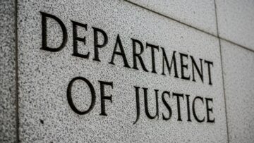 Department of Justice” engraved in grey, stone-like wall, close up