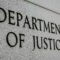 Department of Justice” engraved in grey, stone-like wall, close up