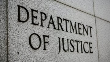 Department of Justice” engraved in grey, stone-like wall, close up