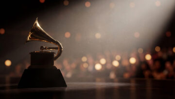 Golden trophy under stage spotlight. Grammy trophy on podium for Grammy Awards Ceremony promo, music awards show night, trophy glow with bokeh crowd, copy space, gala theme, luxury concept