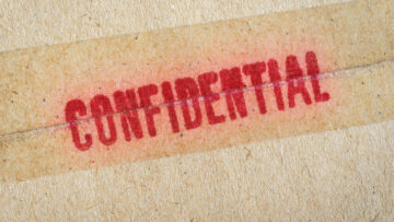 Red “Confidential” word printed on brown vintage envelope.
