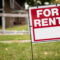 For rent sign in the yard in front of a house