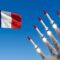 French nuclear arsenal concept a powerful display of military might with missiles launching against a clear blue sky, alongside the waving french flag, symbolizing national defense