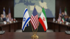 Flags of Israel, United States, and Iran displayed on a table during a diplomatic meeting in a conference room setting, concept of peace agreements, diplomacy, Middle East conflict