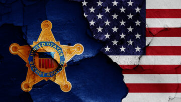 flags of United States Secret Service and USA painted on cracked wall
