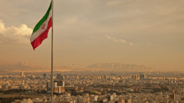 Iran Flag in the Wind Above Skyline of Tehran