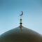 Golden minaret of the mosque. Symbol of Islam. The Golden Crescent.