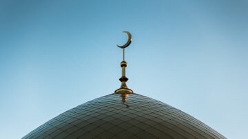 Golden minaret of the mosque. Symbol of Islam. The Golden Crescent.