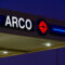 An ARCO gas station canopy with illuminated brand signage at night, illustrating retail fueling operations, petroleum distribution, and consumer transportation services
