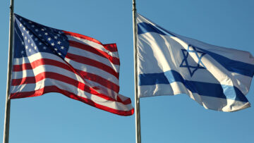 American and Israeli flags waving in the blue sky