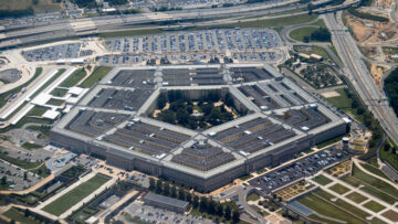 Aerial view of the Pentagon complex with surrounding roads, parking and greenery. g