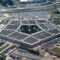 Aerial view of the Pentagon complex with surrounding roads, parking and greenery. g