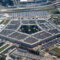 Aerial view of the Pentagon complex with surrounding roads, parking and greenery. g