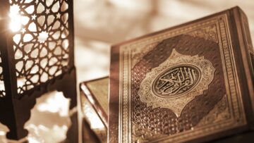 Islamic Book Koran with rosary on grey