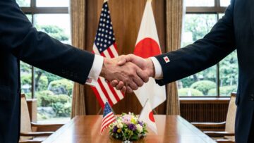 Diplomatic handshake between representatives symbolizing a firm and respectful bilateral agreement between the United States and Japan fostering international partnership and mutual respect.