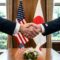 Diplomatic handshake between representatives symbolizing a firm and respectful bilateral agreement between the United States and Japan fostering international partnership and mutual respect.