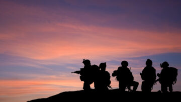 Silhouette of modern troops in Middle East silhouette