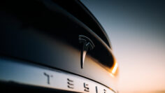 Tesla logo on the trunk of a Model X in the evening. Tesla Motor Company badge. Luxury electric car brand