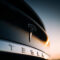 Tesla logo on the trunk of a Model X in the evening. Tesla Motor Company badge. Luxury electric car brand
