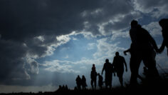 Immigration of people blue sky with dark clouds
