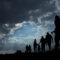 Immigration of people blue sky with dark clouds